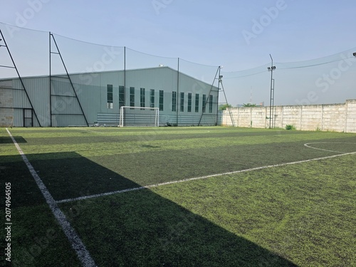 Aerial view of soccerfield at outdoor with blurred background. Sport photography concept design. Mini soccer arena at urban city with artificial green grass.