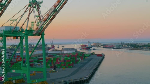 Industrial container port terminal and gantry crane at sunrise