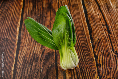 Obraz na plátně Fresh bok choy on rustic wooden surface