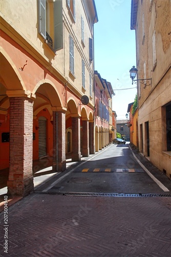 Fotografie Historic street with traditional porticoes and archways in Modena, Italy