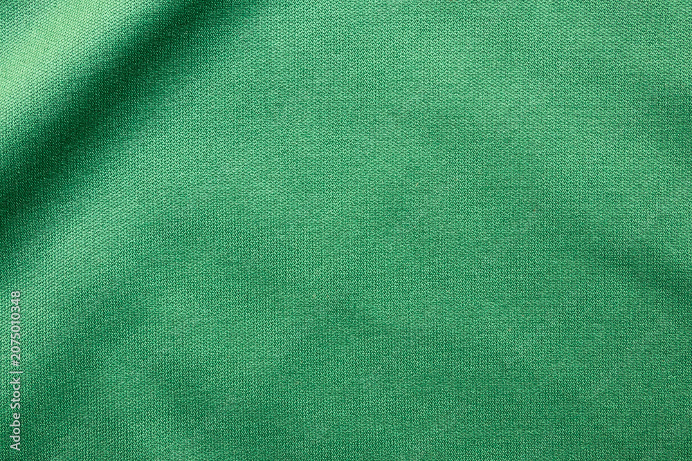 Fototapeta premium Green sports clothing fabric football shirt jersey texture close up