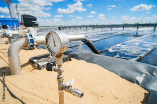 Sewage treatment plants or wastewater treatment systems, on a sunny summer day.
