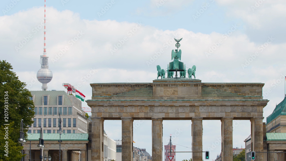 Obraz premium Brandenburg Gate with Quadriga Sculpture and Berlin TV Tower Background