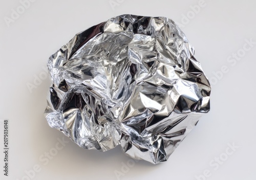 Crumpled Shiny Aluminum Foil Ball Isolated on White Background.