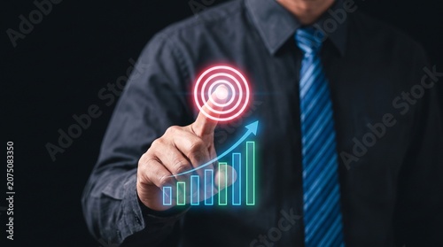Professional businessman touching digital target icon and growth chart for strategic financial success and corporate development in a dark office