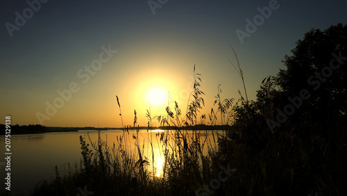 Obraz na płótnie Amazing view at scenic landscape on a beautiful lake and colorful sunset with re