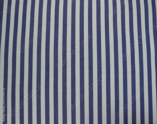 Texture of classic blue striped cotton cloth background. Close up of blue and white vertical striped fabric.