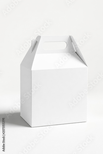 Minimalist white cardboard cake box or gift take-out packaging with an integrated handle, isolated on a clean, solid white background