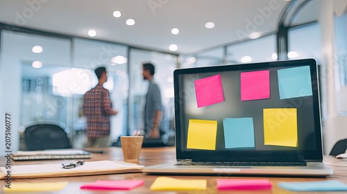 team brainstorming with sticky notes and laptops in bright startup office