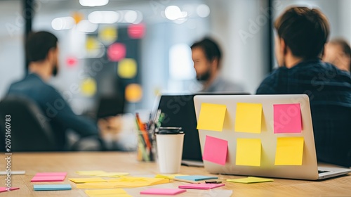 team brainstorming with sticky notes and laptops in bright startup office