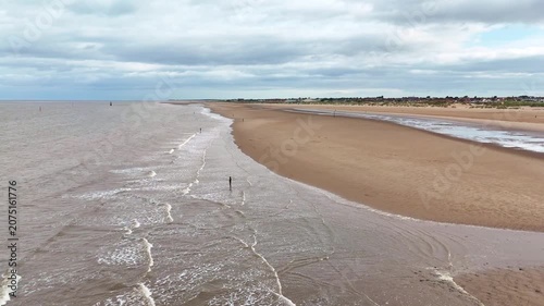 Aerial view of Crosby Beach shoreline and waves at low tide