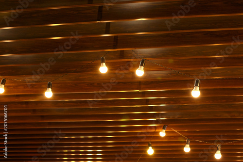 Tableau sur toile Festive String Lights on Wooden Ceiling for Party Celebration