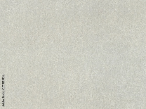 Light-grey surface of hard paper material, background, texture. Gray backdrop. Slightly fibrous cardboard surface. Grayish paper wall, covering. Even paper surface of faded grey color. Grey covering