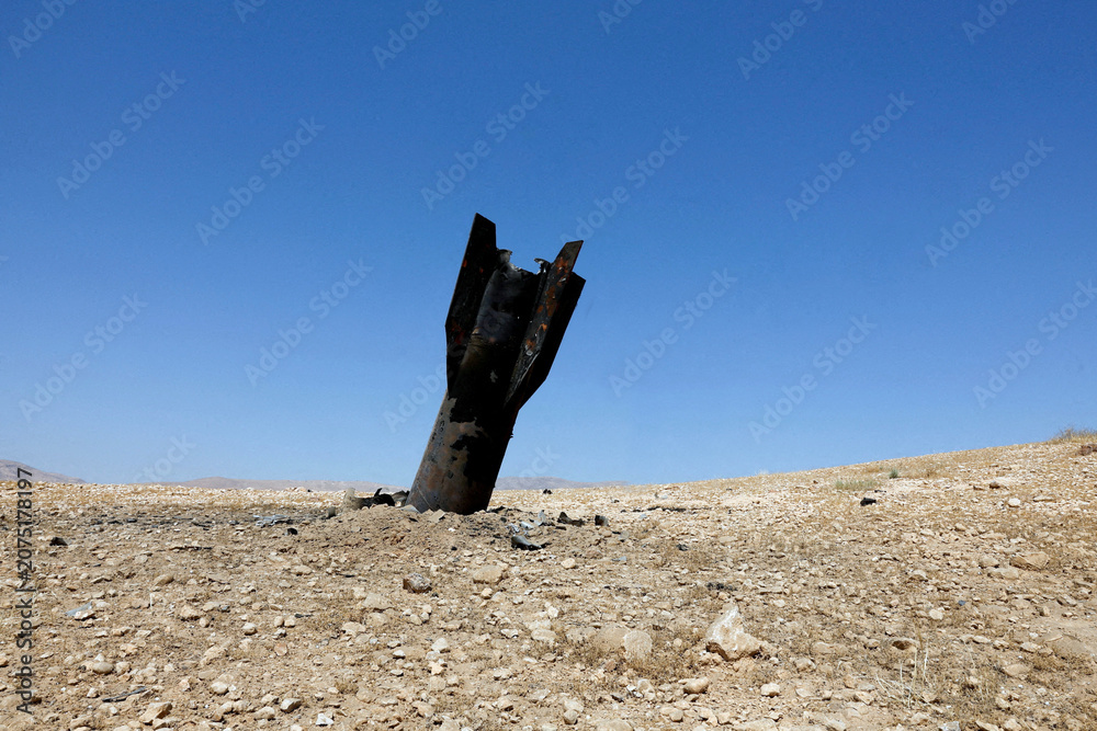 Obraz premium Israel - April 27 2026: An Iranian ballistic missile protrudes from the ground following a strike launched from Iran, capturing a dramatic image of the escalating direct military confrontation.