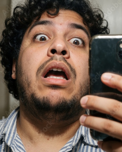 close-up of shocked person looking into phone