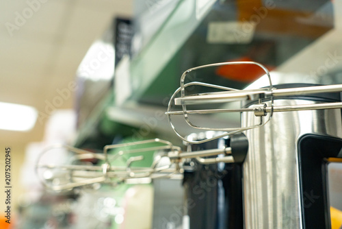 A Close-Up View of Hand Mixer Attachments Displayed on a Kitchen Shelf, Showcasing Their Sleek Design and Functionality for Mixing and Baking Tasks