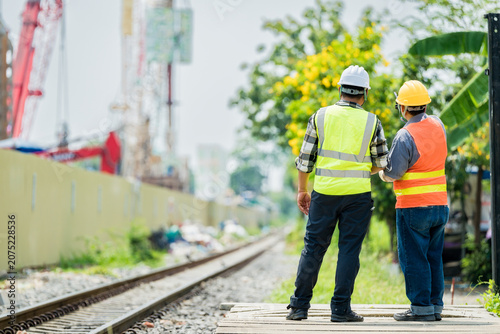 Принти на полотні High-visibility workers inspecting railway construction
