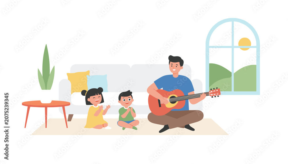 Obraz premium Young father sitting on the floor playing acoustic guitar for his two happy children in a bright living room with a sofa and plants.