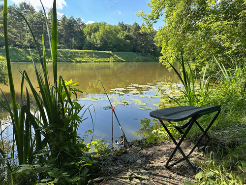 Spinning Rod Casting into Scenic River with Lush Green Nature and Blue Sky, Freshwater Fishing Landscape