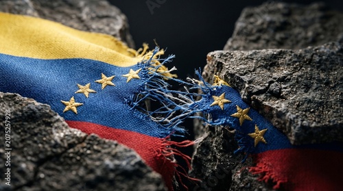 Tattered Venezuela Flag Ripped Between Cracked Rocks Representing Crisis and Earthquakes