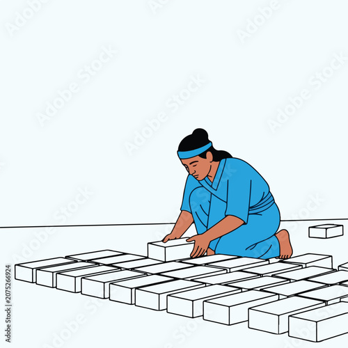 Person laying white blocks in neat rows on a flat surface