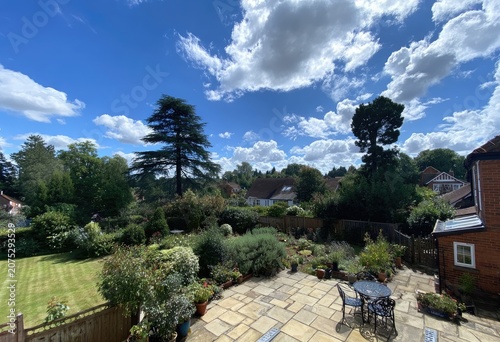 Sunny garden patio overlooking a village