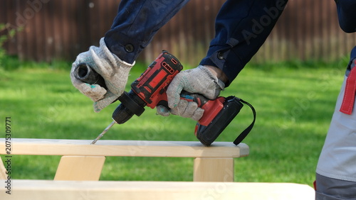 Konstfotografi Builder worker using cordless hammer drill