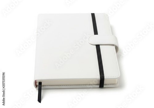 A white leather journal with black elastic closure