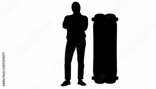 Tableau sur toile Skateboarder standing confidently with crossed arms beside skateboard
