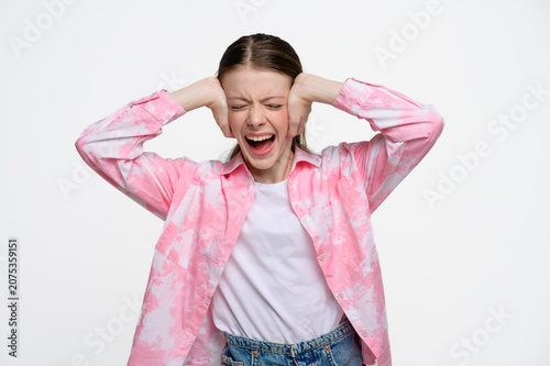 Canvas-taulu Teenage girl covering her ears and screaming with eyes closed