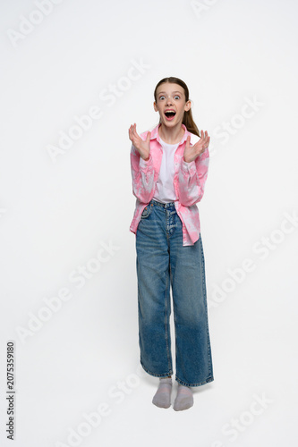Bild auf Leinwand Shocked teenage girl with wide eyes and open mouth expressing surprise, amazement and disbelief