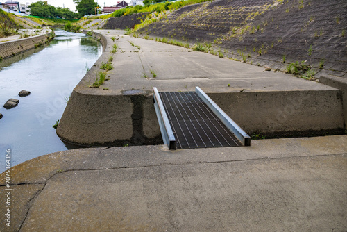 Photos Urban river embankment and maintenance crossing