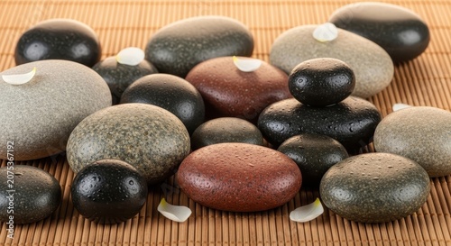 Smooth Stones Arrange Relaxing Spa Environment with Petals