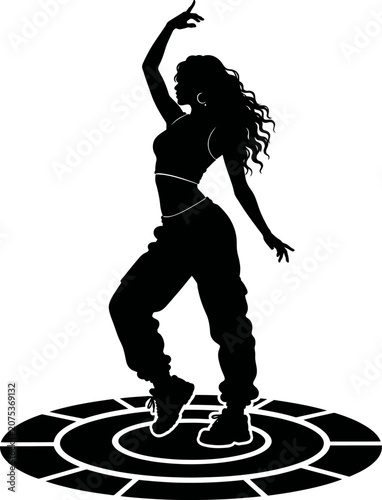 A woman dances energetically on a circular patterned floor indoors.