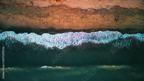 Aerial photography in 4K format – aerial view (ultra-high resolution) of sunset or sunrise on the seashore. Reflection in the water. Beautiful summer seascape of the Mediterranean Sea. Background 