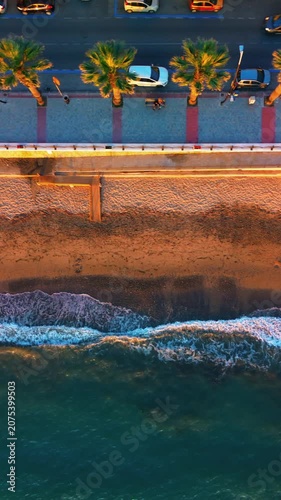 Aerial photography in 4K format – aerial view (ultra-high resolution) of sunset or sunrise on the seashore. Reflection in the water. Beautiful summer seascape of the Mediterranean Sea. Background 