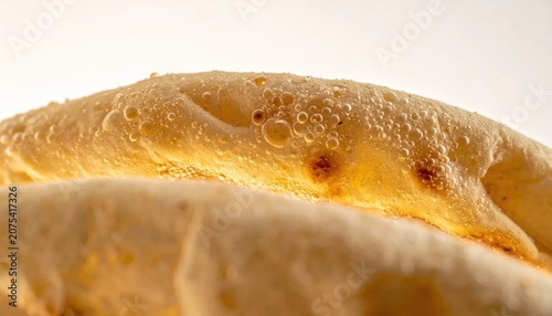 Close up of golden brown baked flatbread crust.