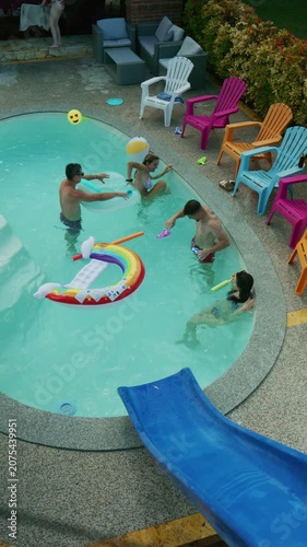 Friends are seen having fun and playing with inflatables in a backyard swimming pool. They are enjoying a refreshing and playful time during the summer.