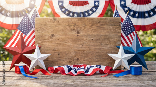 Celebrating 4th of July with patriotic decorations on a wooden table outdoors