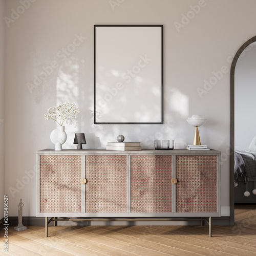 Blank poster frame mockup above rattan sideboard in beige modern interior with sunlight, 3d render