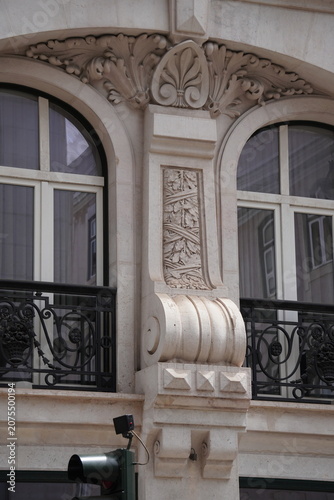 Photos Ornate Neoclassical Building Facade with Carved Stone Arch, Scrollwork and Ironw