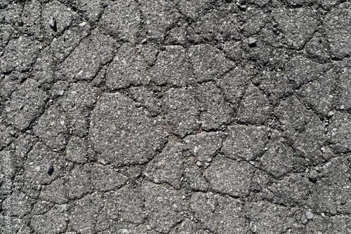 Fotografie A full-frame top-down close-up shot of heavily cracked, broken, and damaged old grey asphalt pavement
