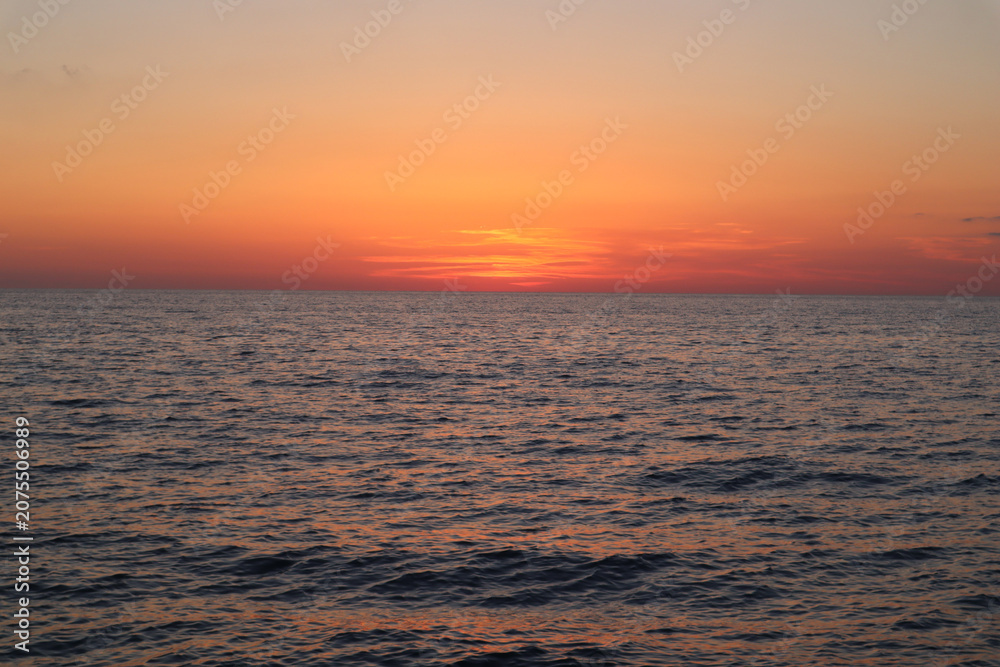 Fototapeta premium Sea sunset with orange sky