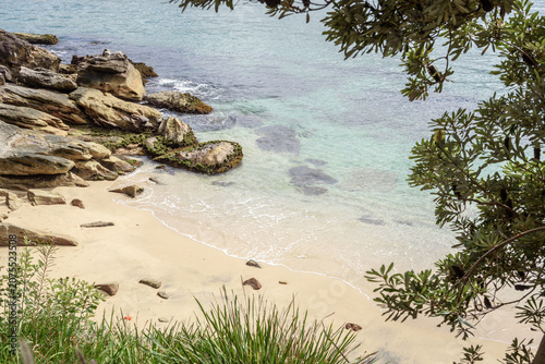 Elevated view of a secluded cove and a deserted sandy beach on a sunny autumn day