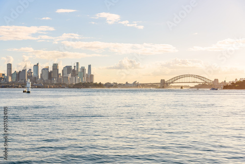 Sydney skyline and harbour at sunset in autumn. A lighthouse is in foreground. NSW, Australia.
