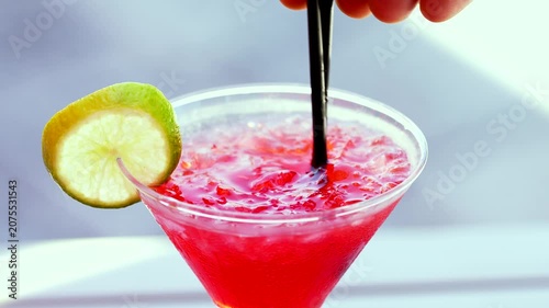 Male Hand Stirring Red Cocktail with Straws in Glass Close Up – Refreshing Tropical Summer Drink Macro Video 4K