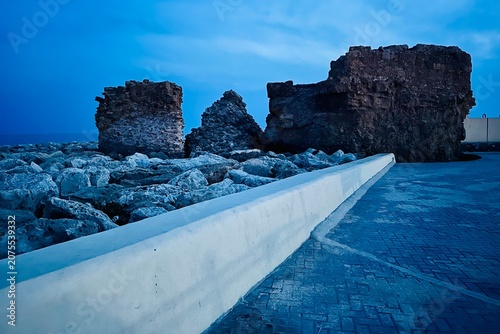 Meditatrenean waterfront with big rocks on the water edge along the promenade in Paphos, Cyprus.