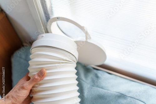 Installing a portable air conditioner exhaust hose into a custom polycarbonate window kit