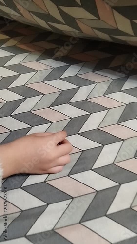 Child putting baby tooth under the pillow for Tooth Fairy, Close up of kid's hand hiding milk tooth under blanket