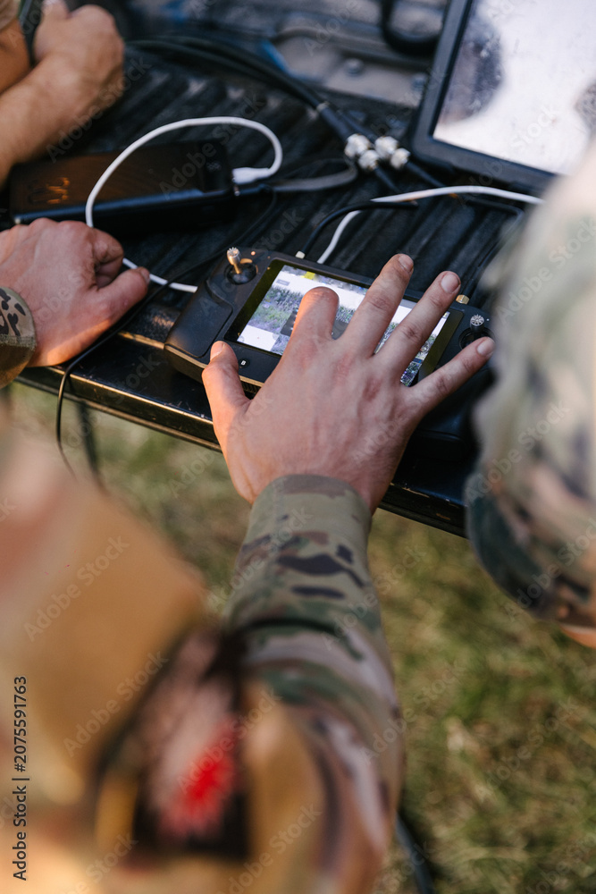 Fototapeta premium Ukrainian military operating drone controller on battlefield